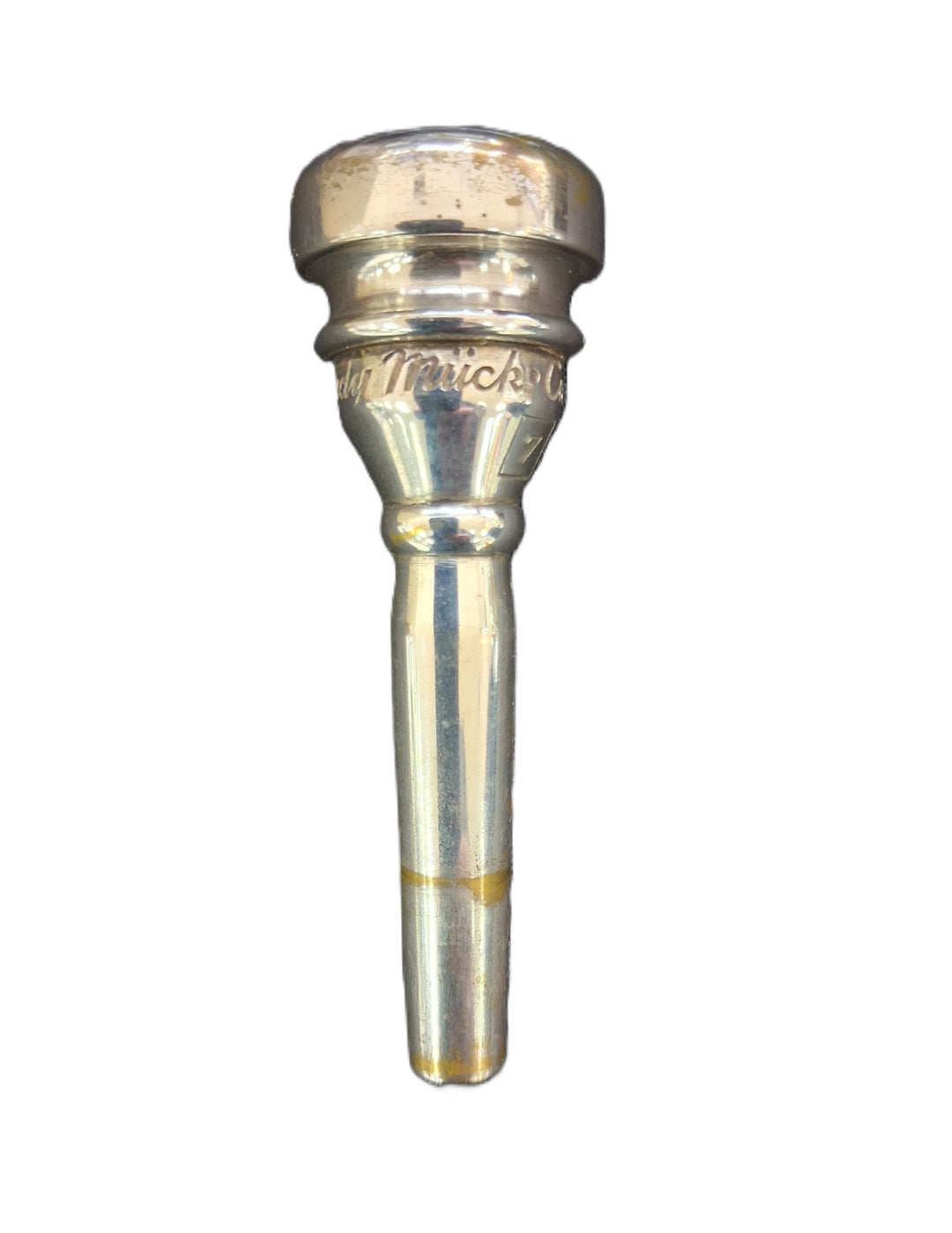 A silver metal trumpet mouthpiece with 'Rudy Muck' engraved on the band