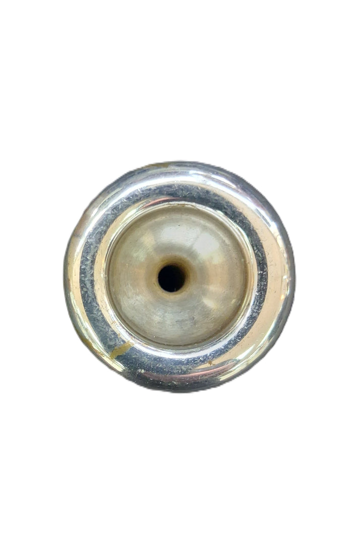 A close-up top-down view of a trumpet mouthpiece