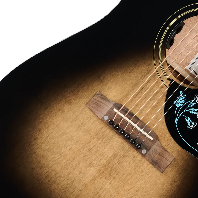Close-up of an acoustic guitar body showing the natural wood grain, sound hole, bridge, and part of the neck