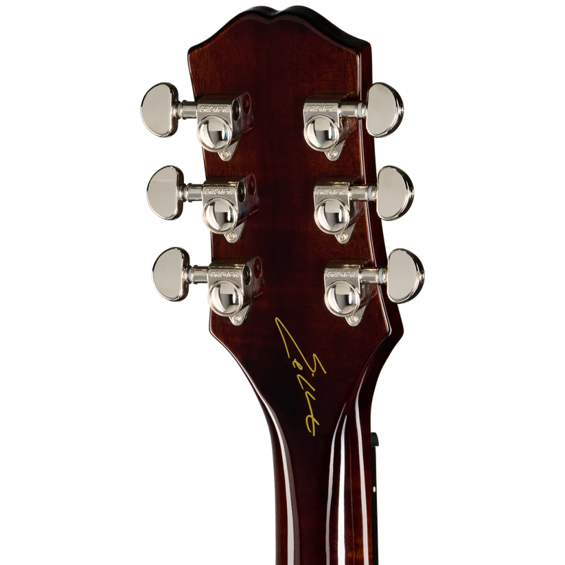 Close-up of the back headstock of a six-string acoustic guitar, showing six silver tuning pegs and a gold script signature on a dark reddish-brown glossy finish.