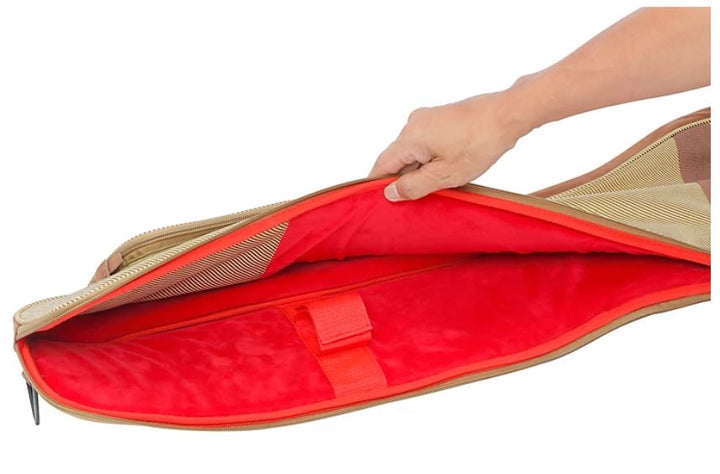 Hand holding a beige bag with a red interior on a white background