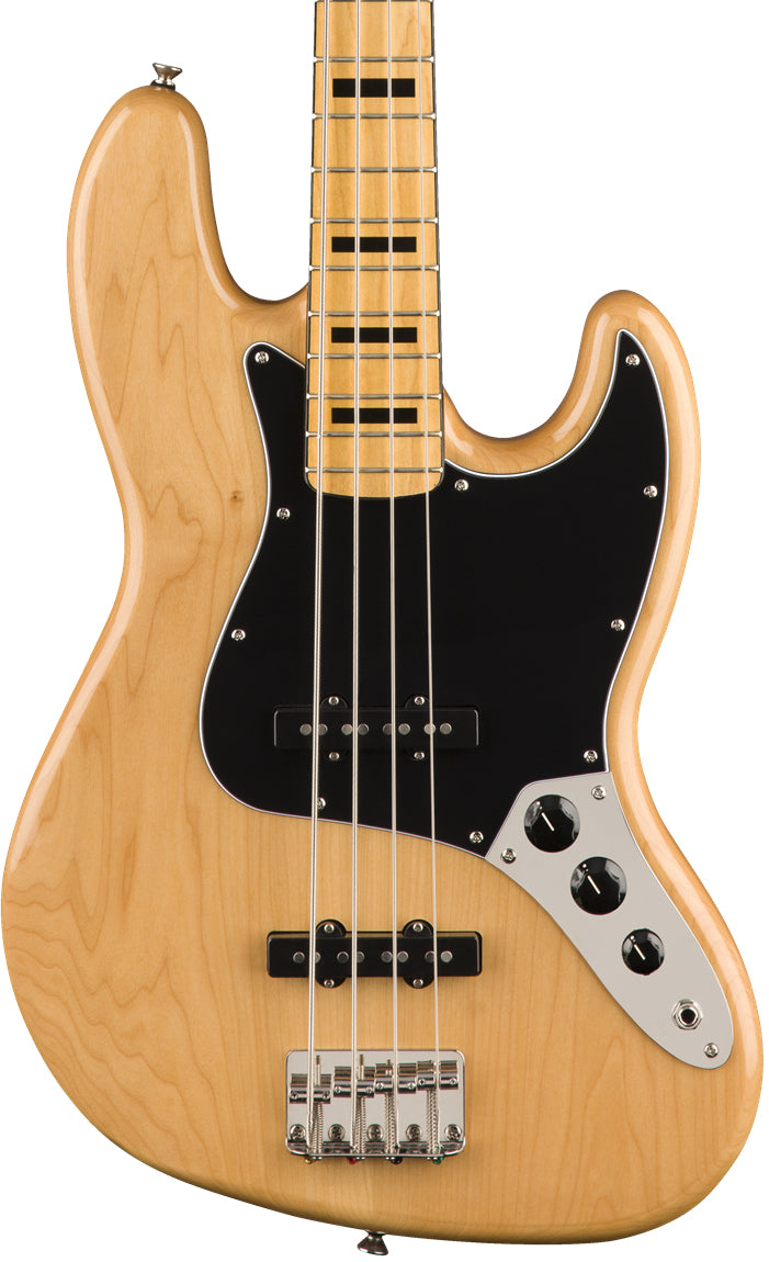 Electric bass guitar with a blonde finish on a white background