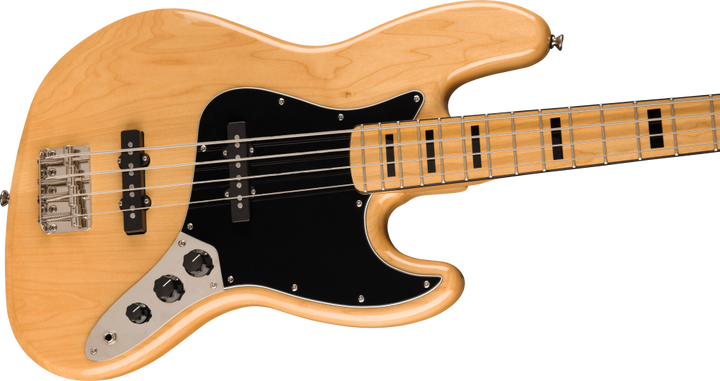 Electric bass guitar with a natural wood finish on a white background